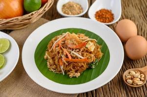 pad thai camarones en un bol con huevos, cebolleta y condimentos foto