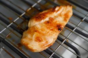 Grilled chicken on an electric grill photo