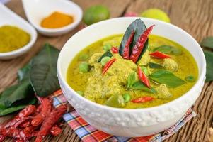 Spicy green curry in a bowl with spices photo