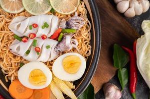 Noodles with squid and boiled egg photo