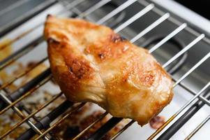 Grilled chicken on an electric grill photo