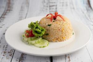 Fried rice with eggs on a wood background photo