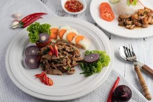 Stir-fried pork basil with carrots, cucumber and onion photo