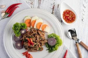 Stir-fried pork basil with carrots, cucumber and onion photo