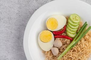 Noodles with boiled eggs and vegetables photo