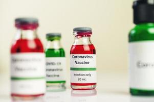 The vaccine against covid-19 in red and green bottles photo