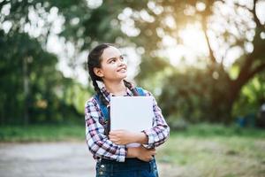 Young female student holding a book photo