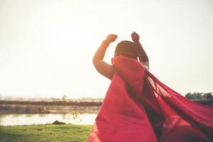 Super boy stands to show super powers photo