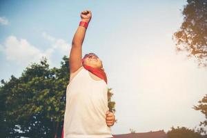 Super boy stands to show super powers photo