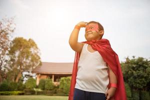 Super boy stands to show super powers photo