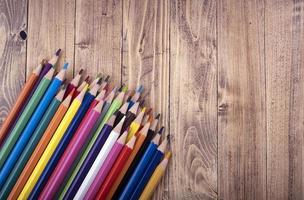 Colored wooden pencils, on a wooden base. education and school concept. photo