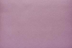 Purple background from a textile material with wicker pattern, closeup. photo