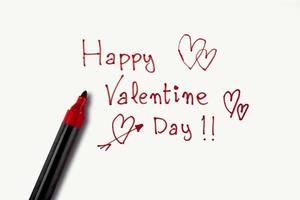 Valentine's Day phrase made with a red marker on a white background. Concept of St. Valentines Day photo