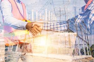 Construction workers shaking hands photo