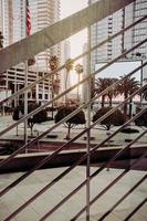 Green palm trees near white concrete building during daytime photo