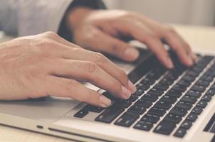 Man hands on the keyboard laptop photo