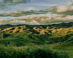 Green mountains under white clouds during daytime photo