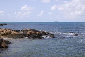 Waves and rocks during the day photo