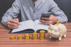 Man with stacked coins photo