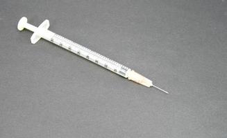 hypodermic syringe on black photo