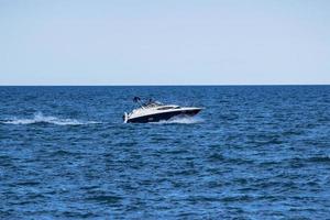 White speedboat on sea during daytime photo