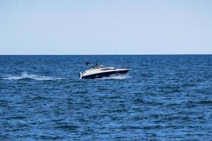 White speedboat on sea during daytime photo