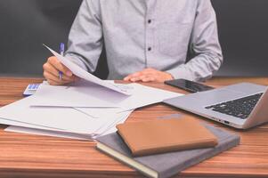 Business people sit at work and check documents At the desk in the room photo