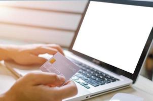 Person using credit card to shop online photo