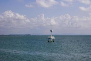 Lighthouse in ocean photo