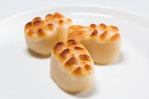 Three marzipan figures on a white plate photo