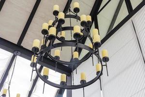 Massive steel chandelier with candles in medieval style, Closeup photo