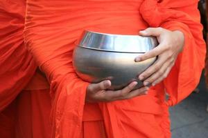 Monk holding silver bowl photo