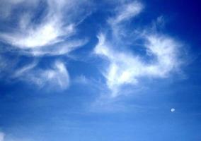 Wispy clouds in blue sky photo