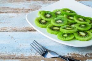 Green kiwi on plate photo