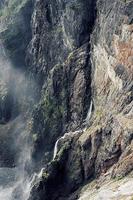 Waterfall through brown mountain photo