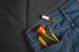 Perfume bottles and fragrances in jeans bags photo