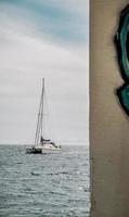 Alicante, Spain, 2020 - White sailboat on sea under white sky during daytime photo