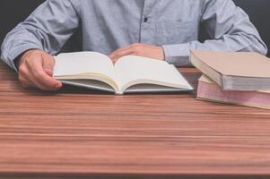 Man reading a book at his desk photo