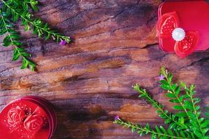 Presents and plants on wooden table photo