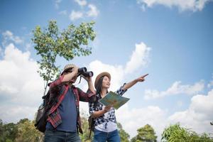 Happy young hikers standing in the forest photo