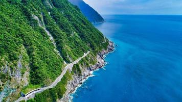 Road along a cliff by the sea photo