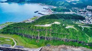 Green hill near the ocean photo