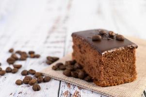 Chocolate cake with coffee beans on a wooden table photo