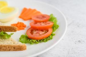 Boiled egg with tomatoes and carrots photo