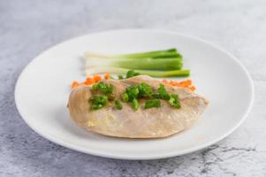 Steamed chicken breast with spring onions and chopped carrots photo