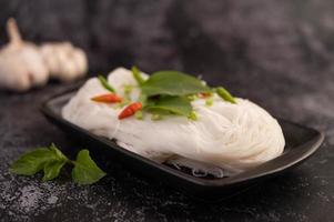 Rice noodles on a black plate photo