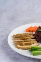 Black rice with pumpkin, peas, carrots, baby corn and steamed chicken breast photo