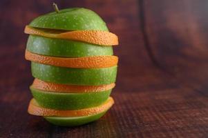 Sliced apples and oranges arranged in layers photo