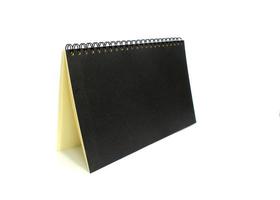 Black notebook on white photo