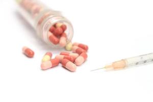Pills and a syringe photo
